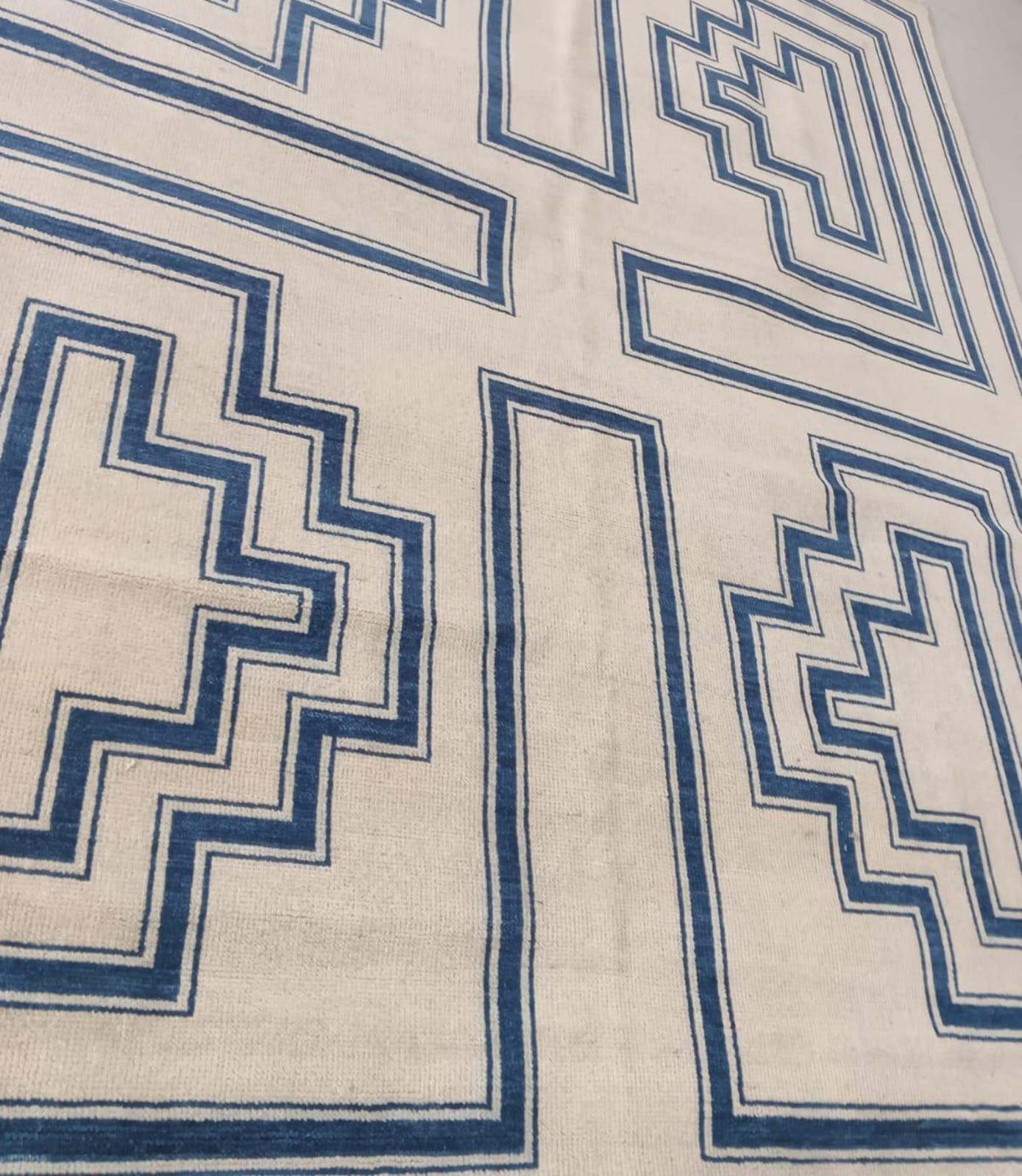 Geometric flatweave rug detail showing clean indigo blue line pattern