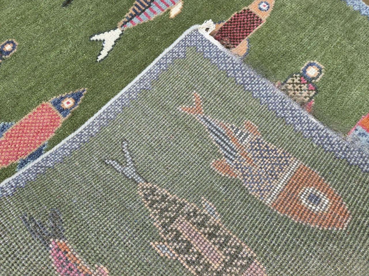 Backside weave detail of handmade coastal fish area rug