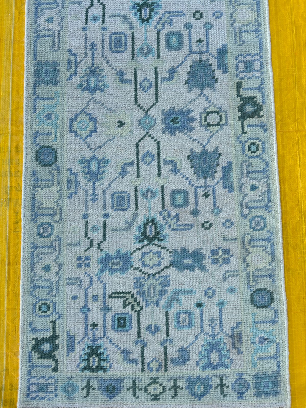 Hand-knotted blue Oushak runner rug with geometric pattern made from wool