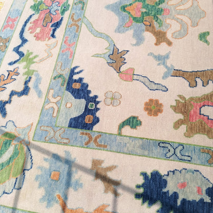 Folded corner of hand-knotted Oushak rug showing thickness and wool pile