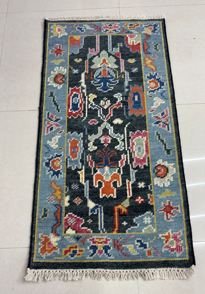 Folded corner of handmade Oushak runner rug highlighting thick wool pile and durability