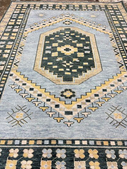 Handmade blue geometric Oushak wool area rug with traditional tribal medallion, charcoal border, and vintage Turkish-inspired design.