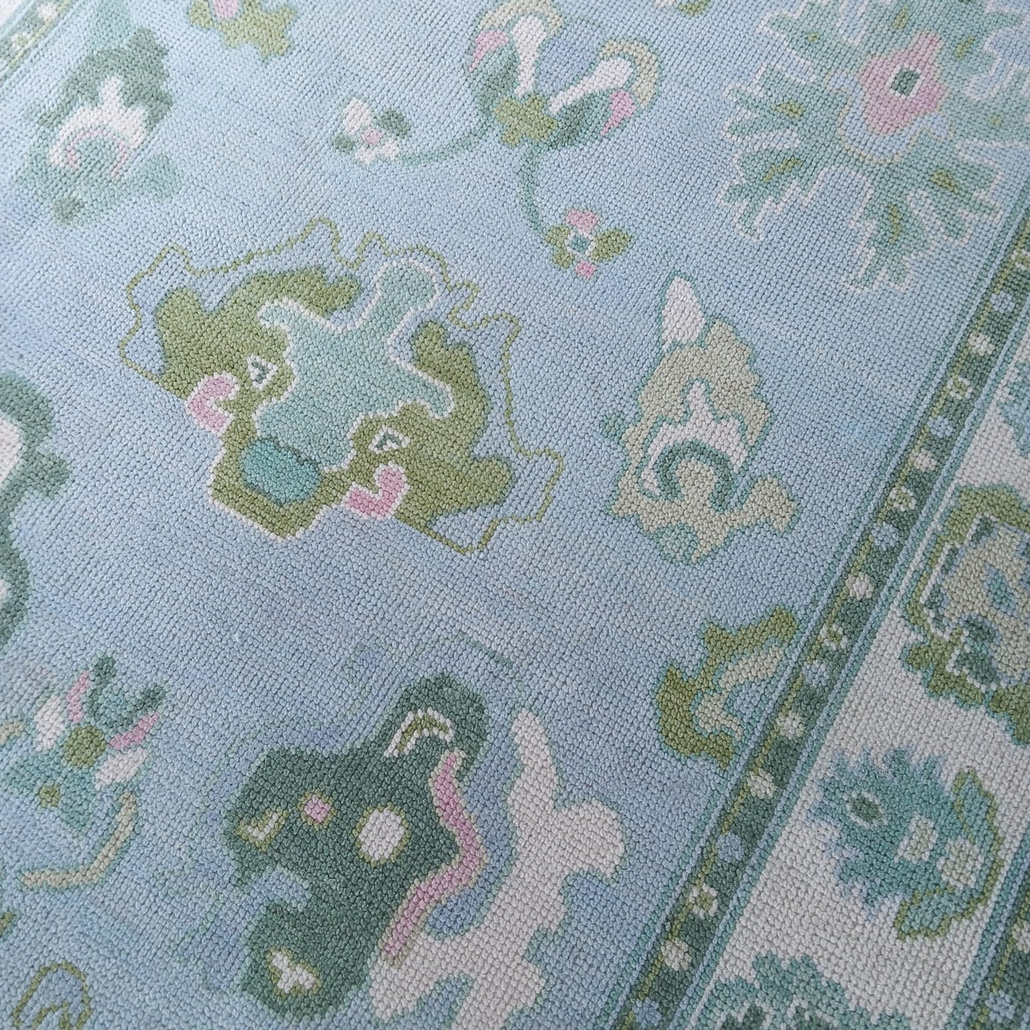 Handmade blue and ivory wool area rug with contemporary leaf pattern suitable for living room or bedroom