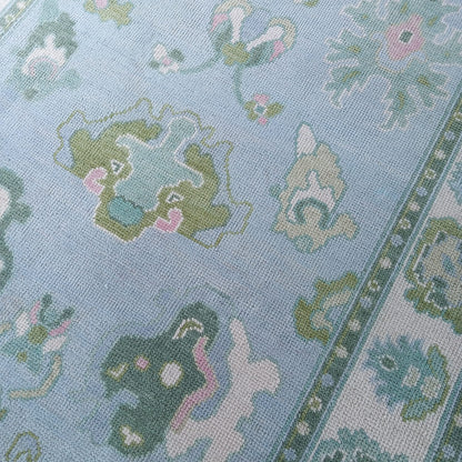 Handmade blue and ivory wool area rug with contemporary leaf pattern suitable for living room or bedroom