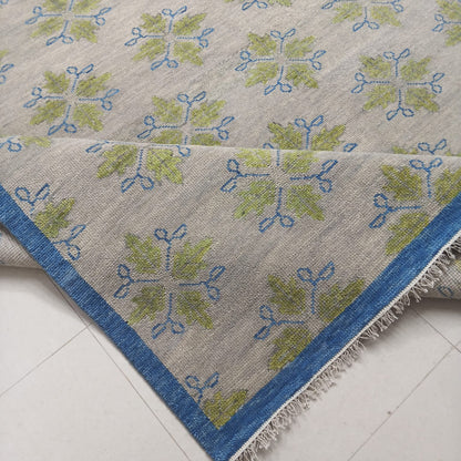 Folded handmade flatweave wool rug showing craftsmanship and low-pile construction