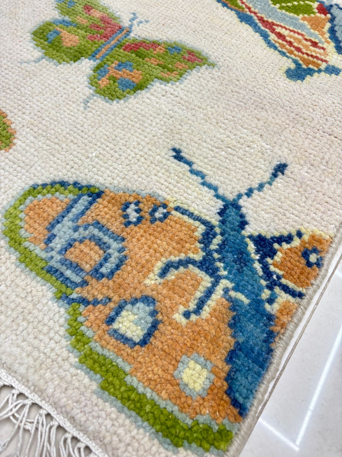 Artisan-crafted butterfly rug showcasing detailed weaving and colorful butterfly design