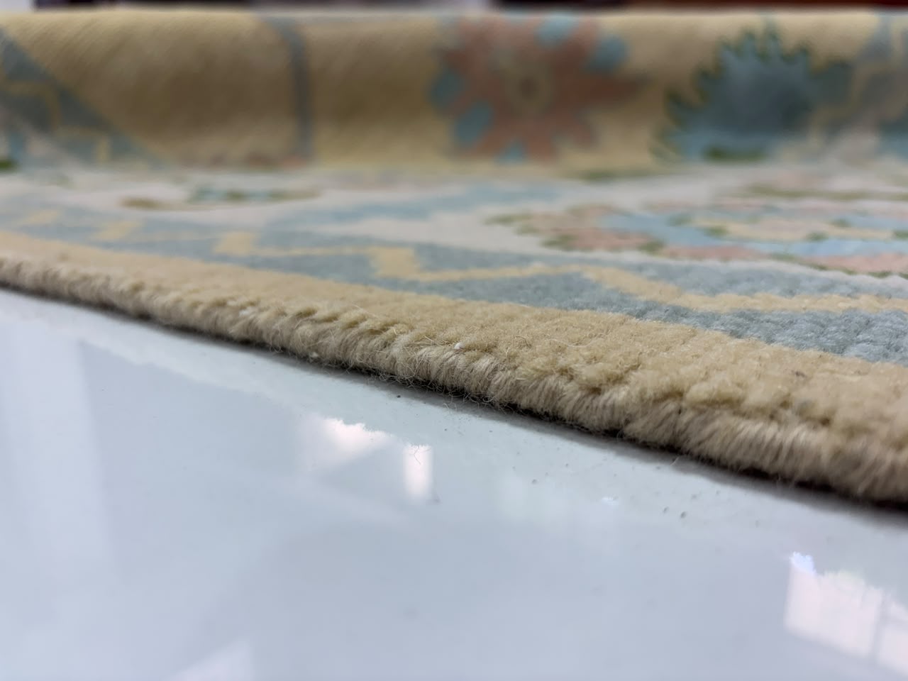 Low pile thickness detail of handmade wool Oushak rug.