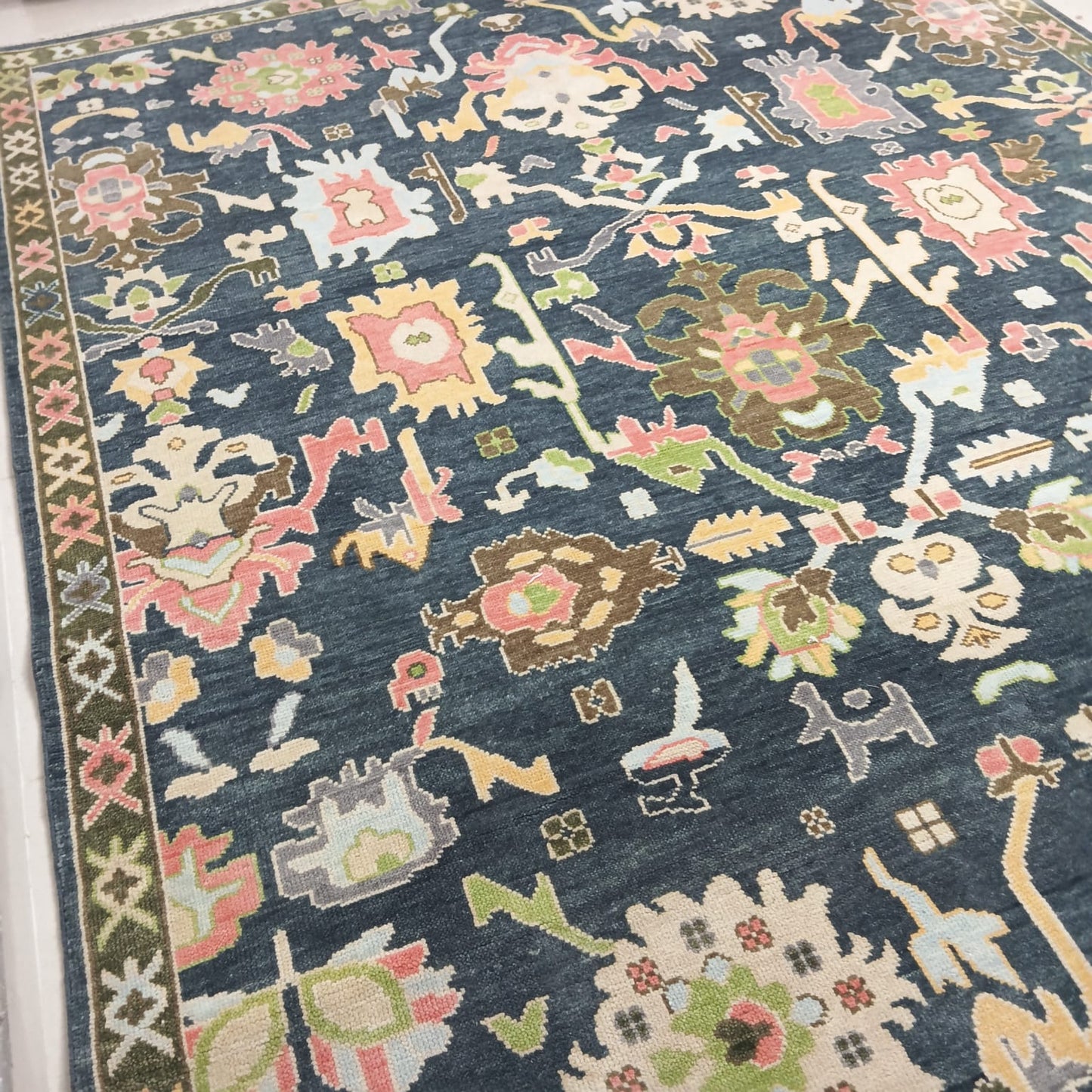 Overall design of handmade Oushak rug with soft pastel accents