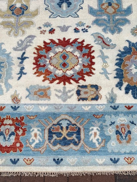 Handmade Oushak rug showcasing detailed Turkish inspired floral motifs and artisan craftsmanship