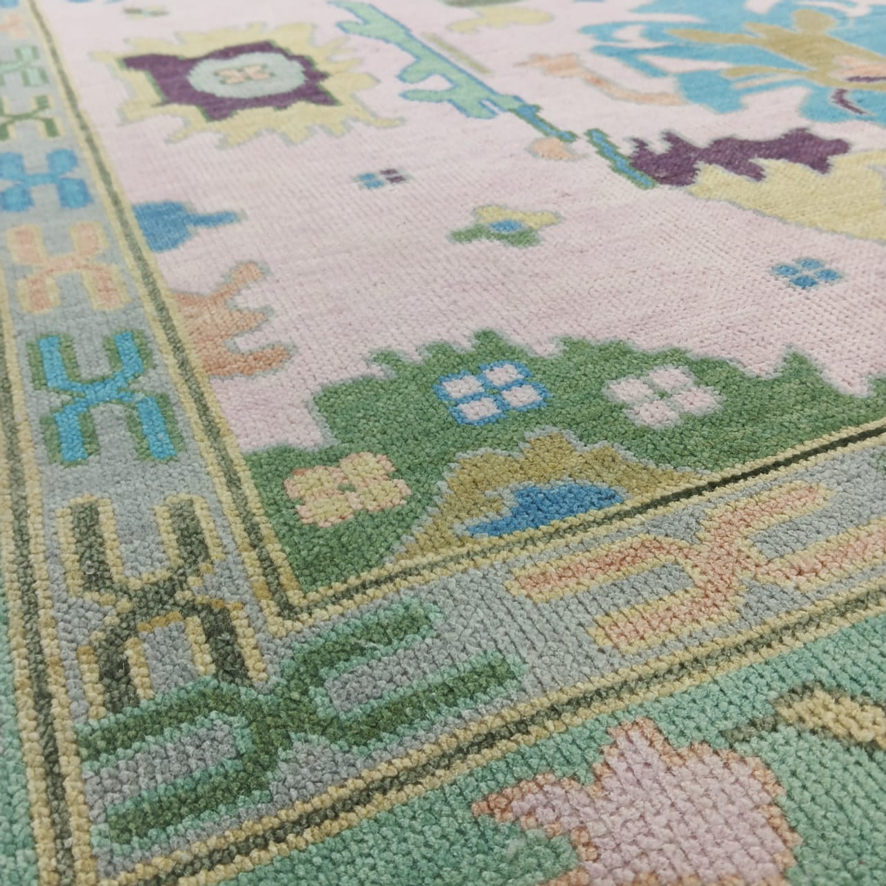 Handmade pastel Oushak rug in pink and green wool with Turkish design