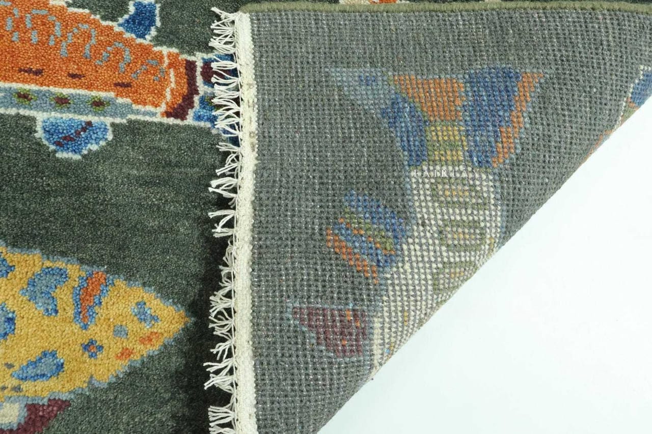 Close-up of a patterned rug with colorful fish design on a gray background