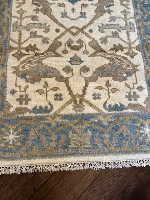 Fringe and border detail of handmade tribal rug with blue geometric pattern