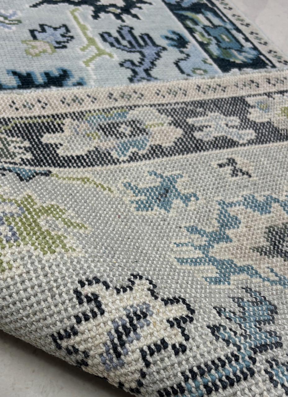 Back weave detail of a handmade wool area rug showing artisan craftsmanship and durable construction.