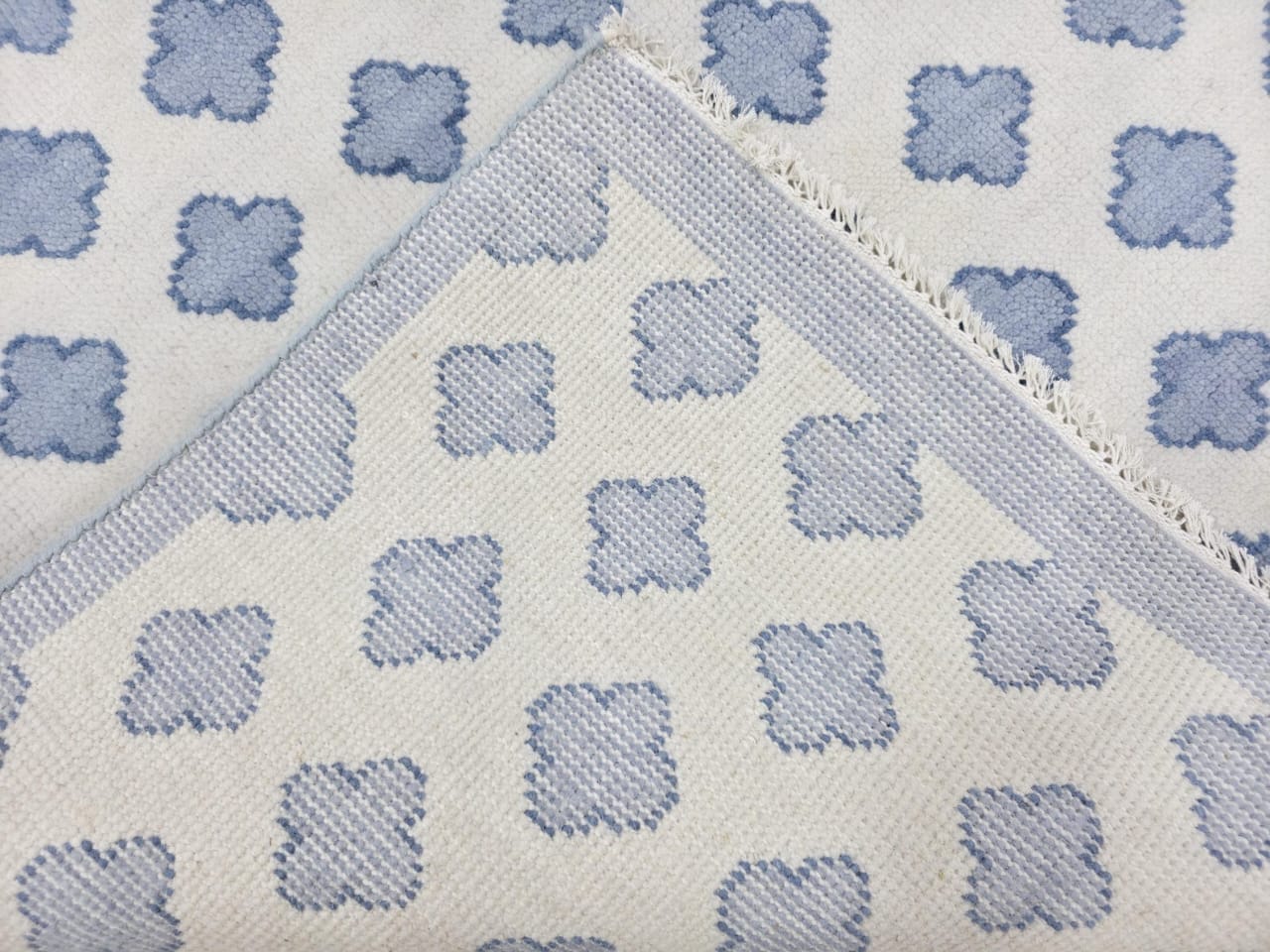 Handwoven blue and ivory Oushak wool area rug with flatweave geometric pattern