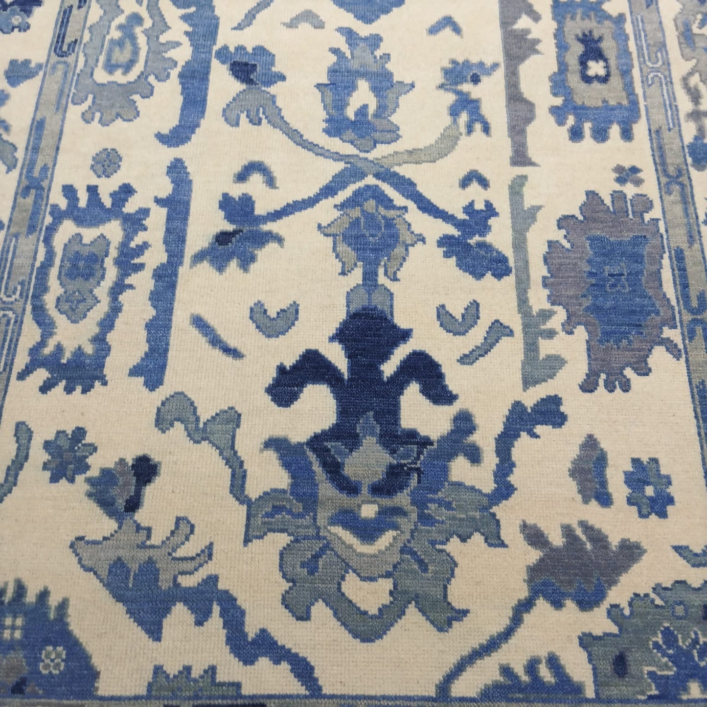 Handwoven blue and ivory Oushak wool rug full view
