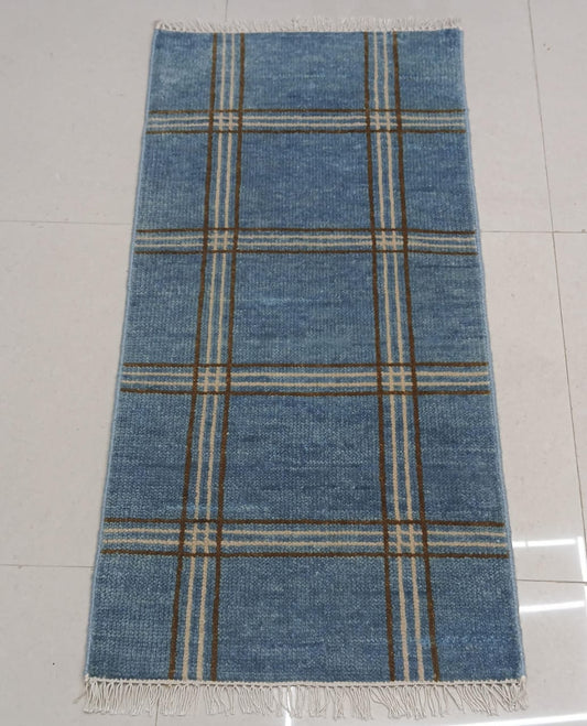 Handwoven blue plaid wool rug with modern checkered pattern and fringe edges
