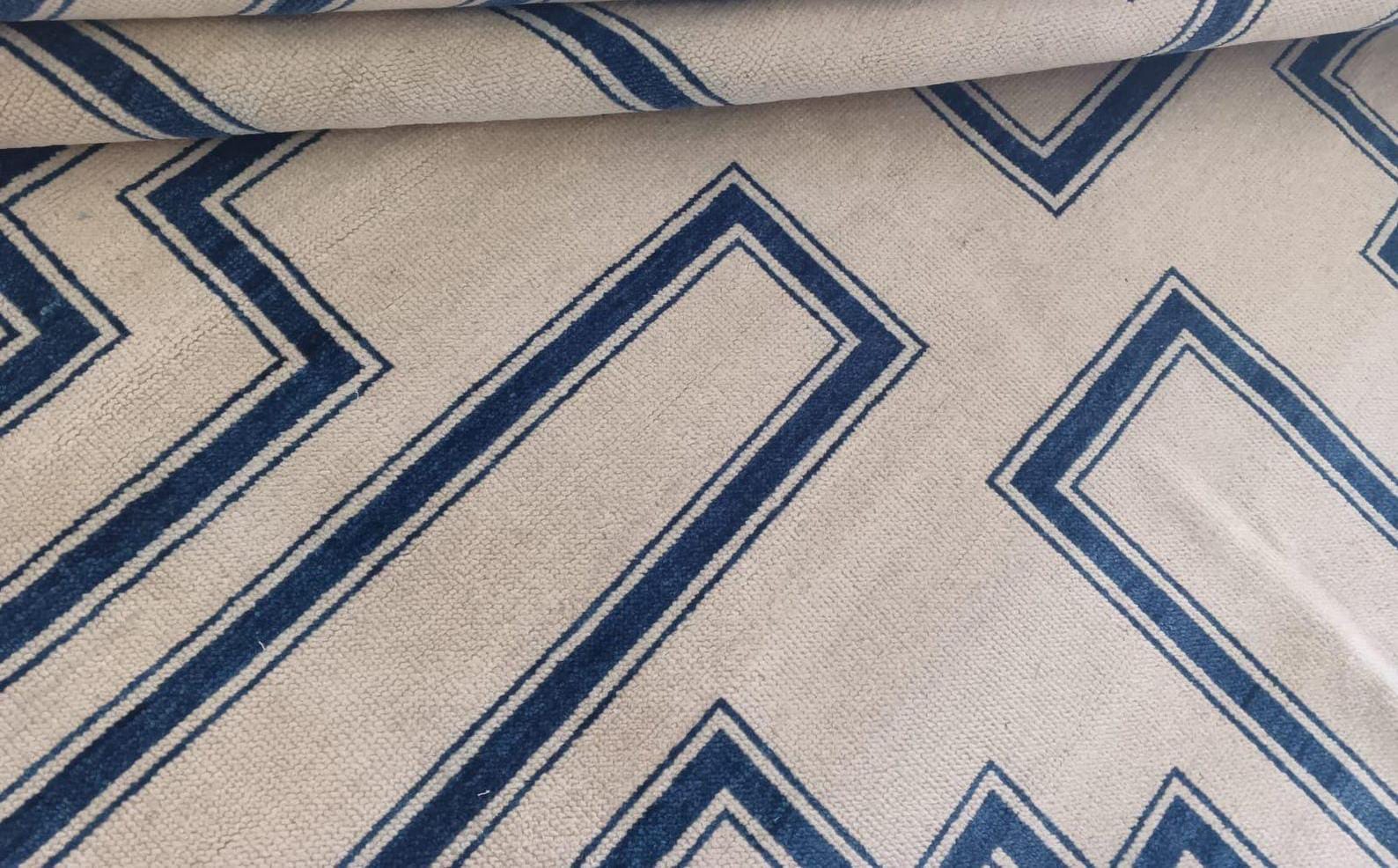 Edge detail of handwoven flatweave wool rug with precise geometric borders
