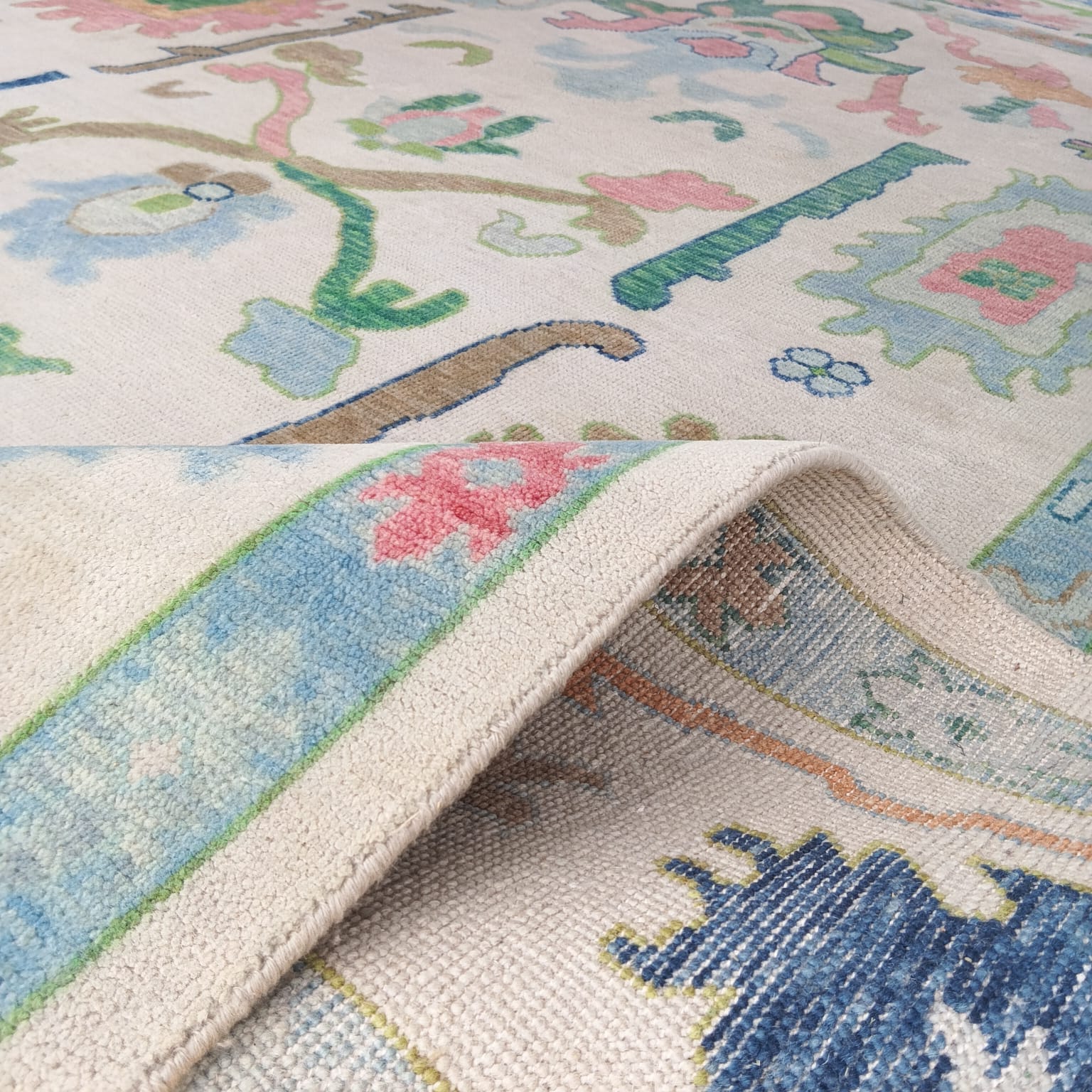 Back weaving of handwoven Oushak rug showing traditional knotting