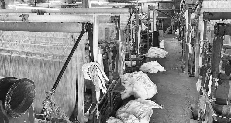 Handwoven Oushak rug being woven on a traditional loom, showing the craftsmanship and weaving process behind each rug