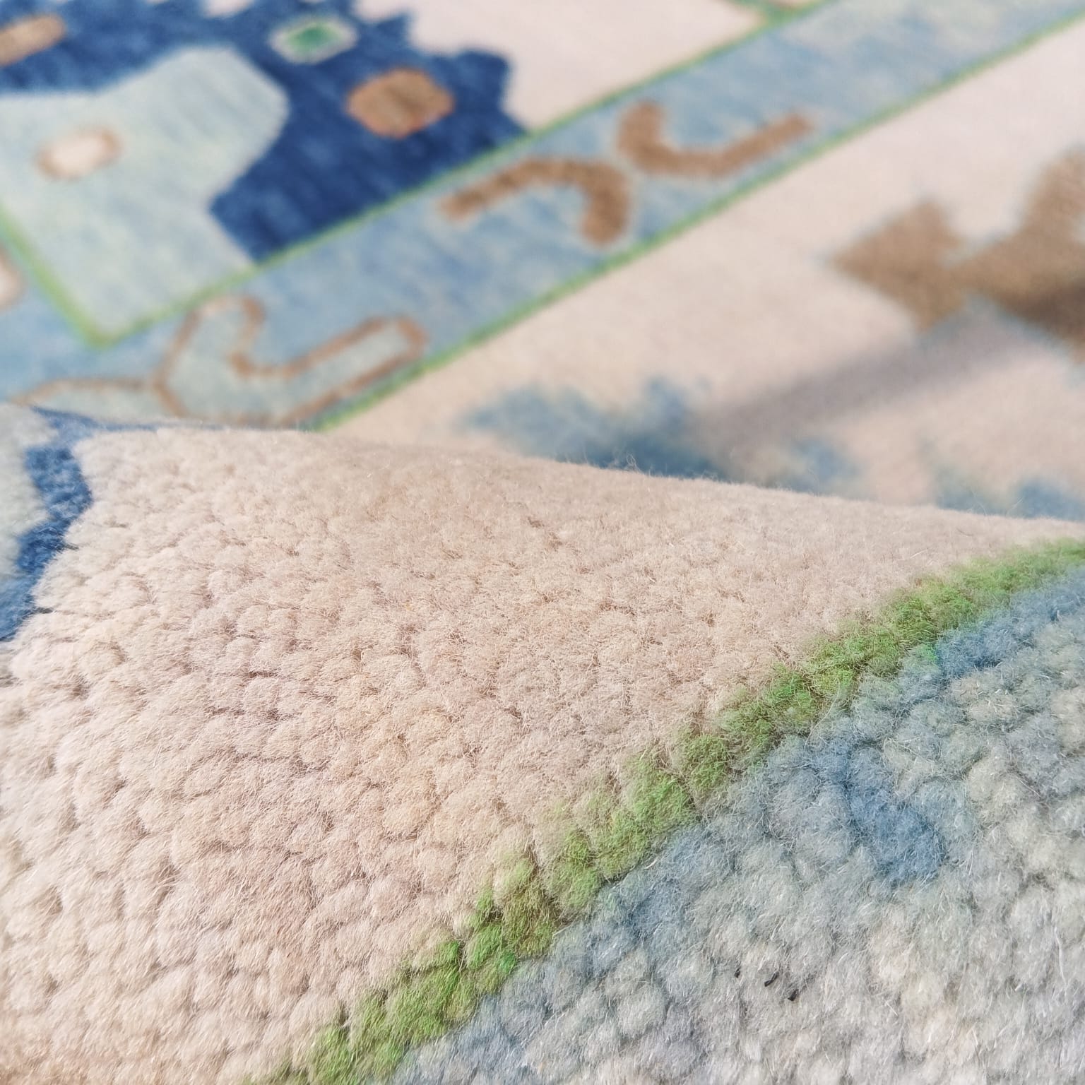 Macro view of handwoven wool Oushak rug showing soft pile and natural texture