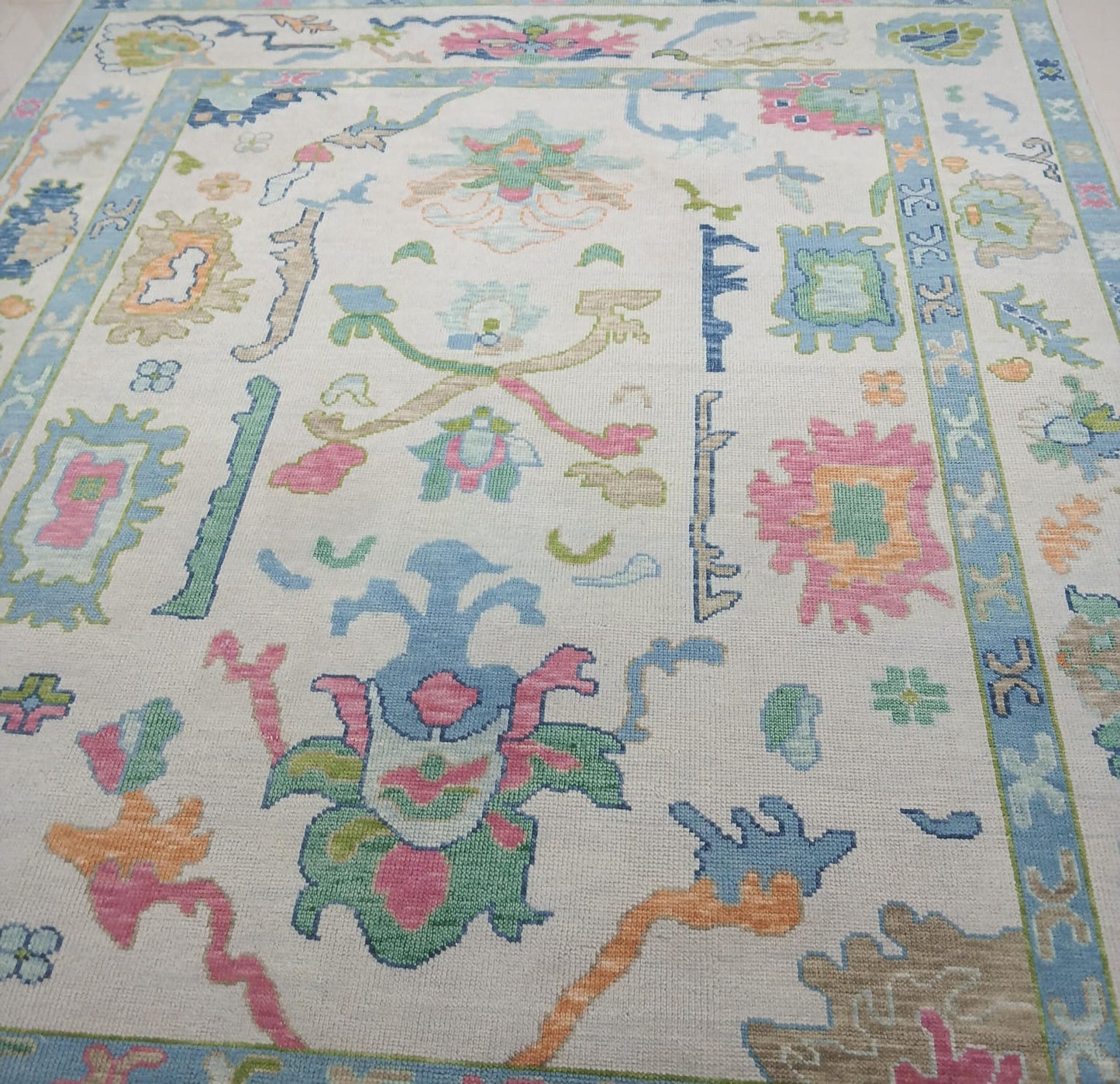 Close-up of handwoven wool texture on Oushak rug