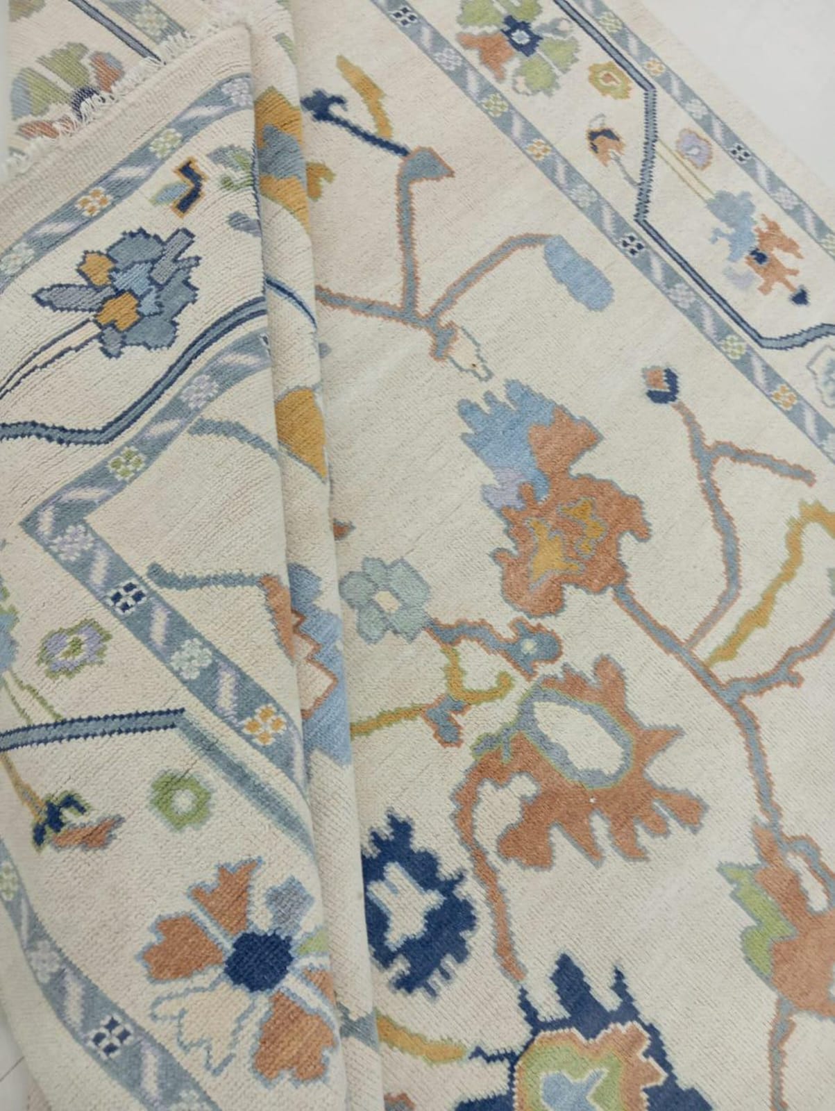 Handwoven wool rug corner detail showing flatweave construction and craftsmanship