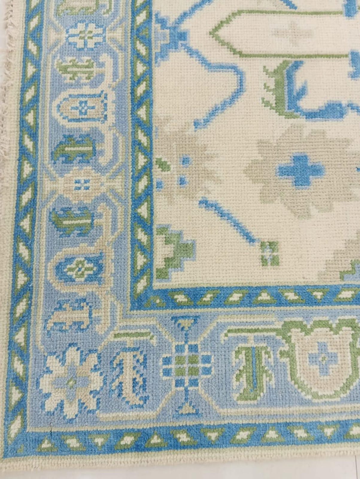 Corner detail of flatweave wool rug showing handwoven craftsmanship