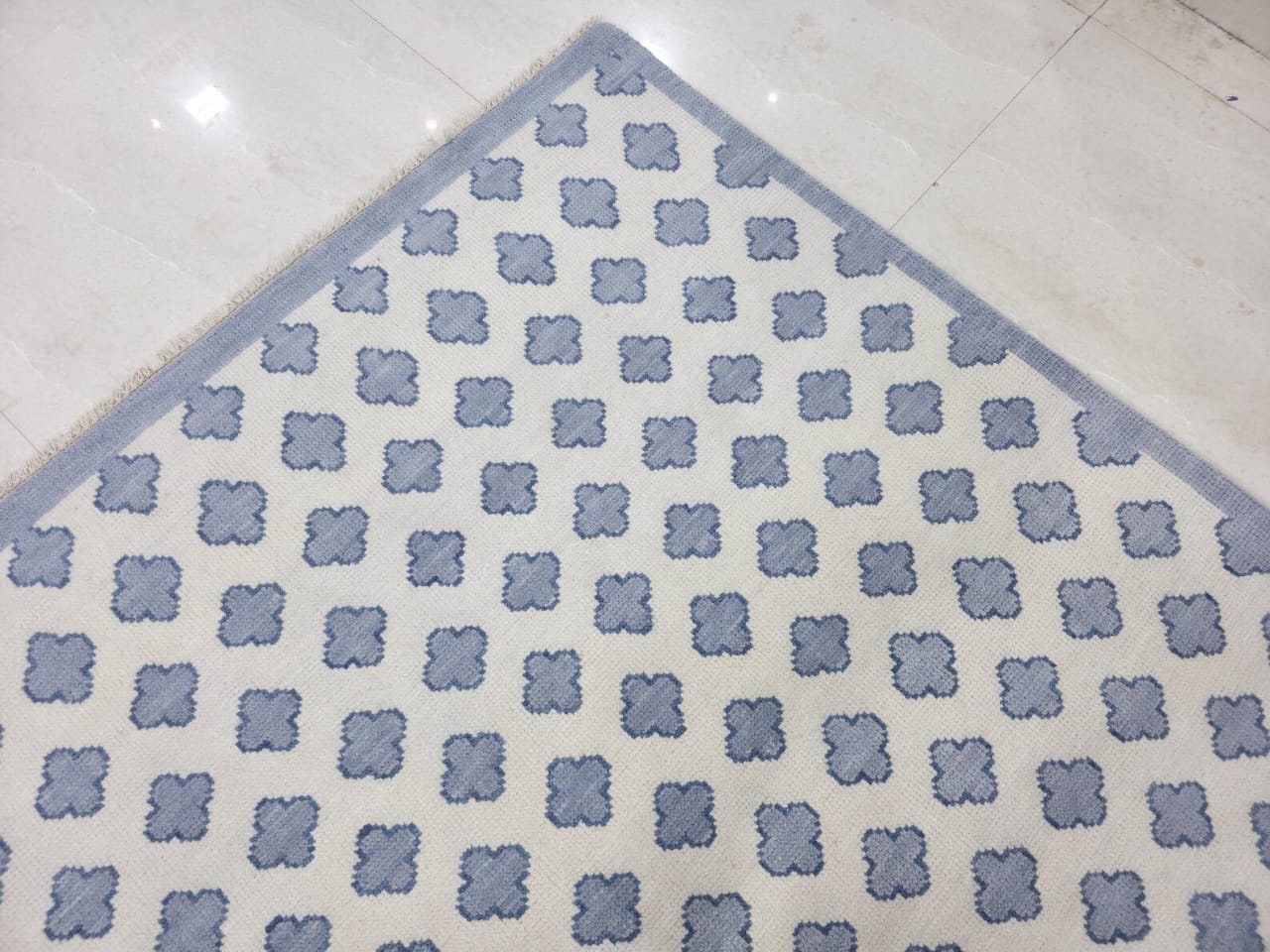 Handwoven wool rug edge detail showing flatweave construction and craftsmanship