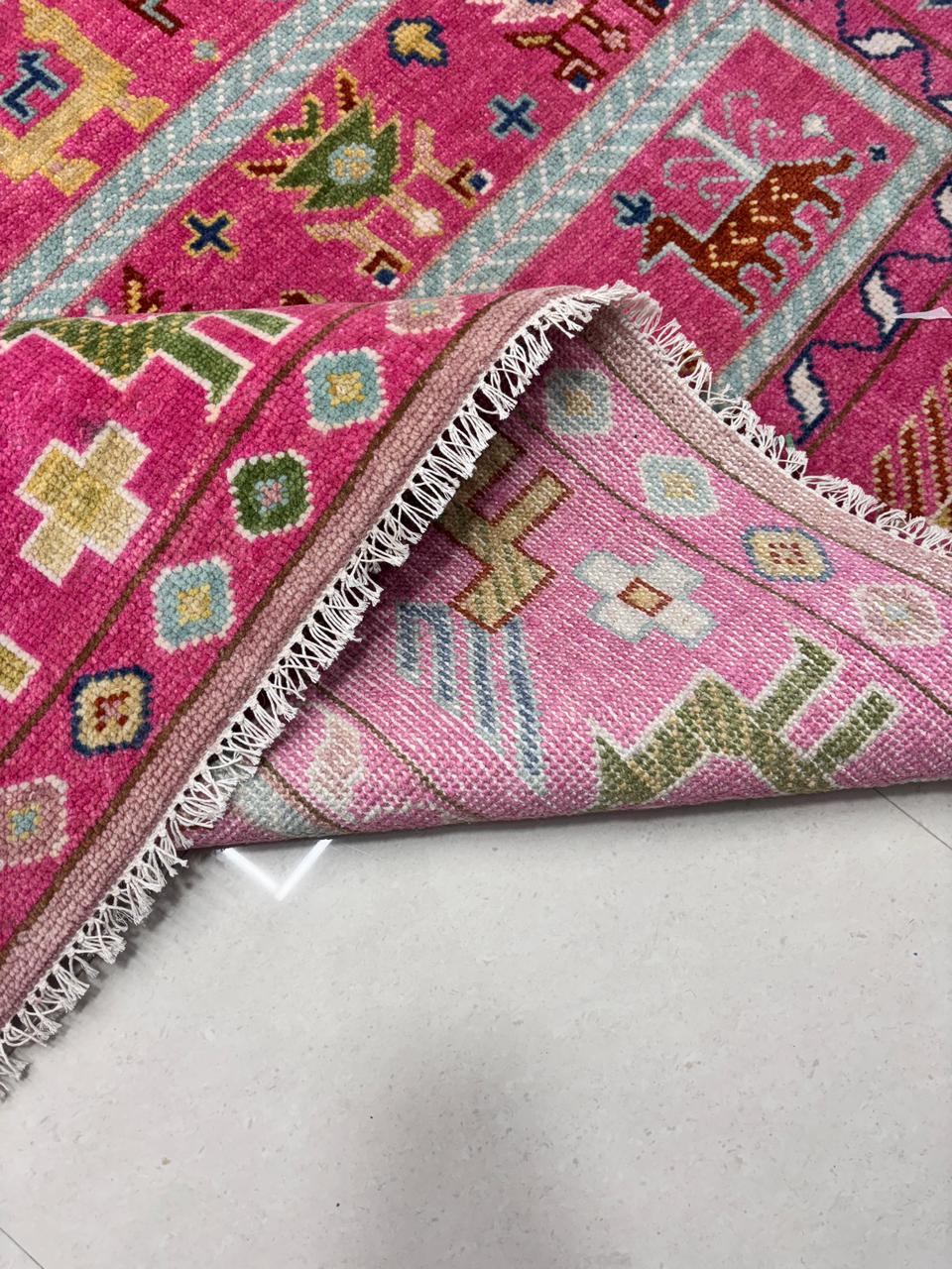 Folded handwoven wool rug showing thickness and texture