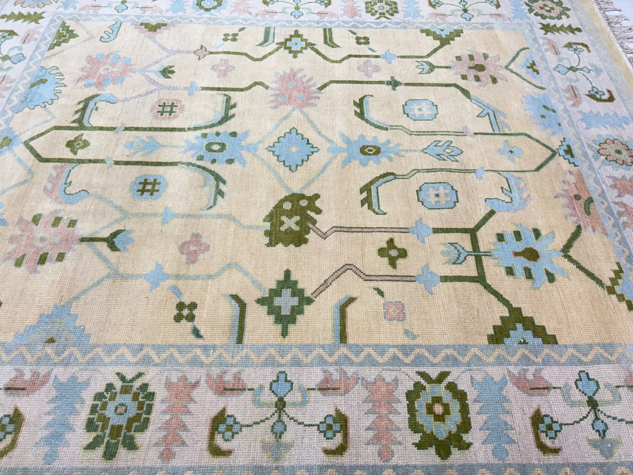 Handwoven wool texture of handmade vintage Oushak rug.