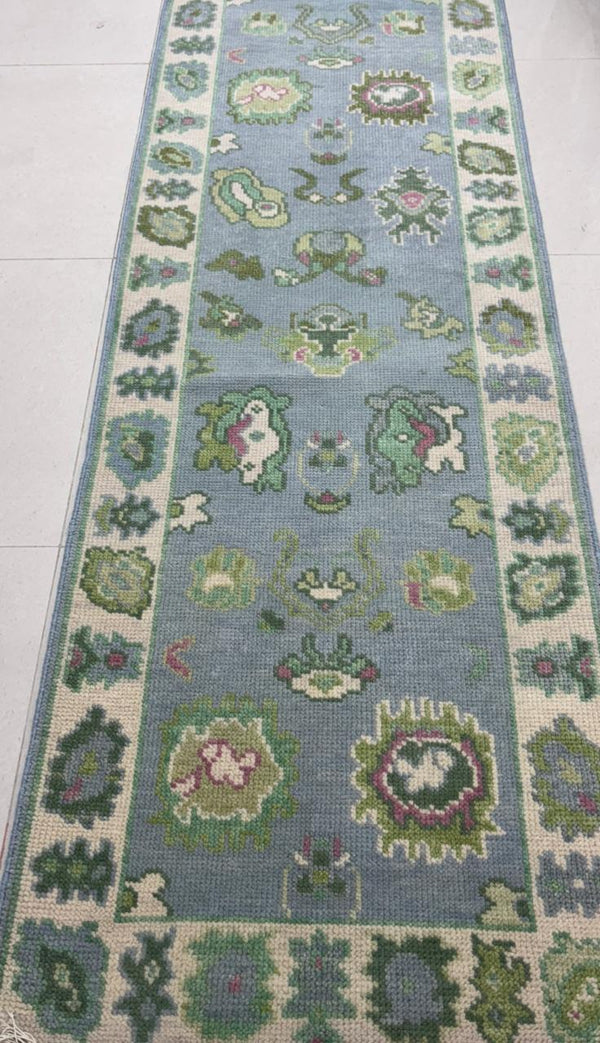 Close view of Oushak rug fold highlighting wool thickness, weave quality, and handmade construction