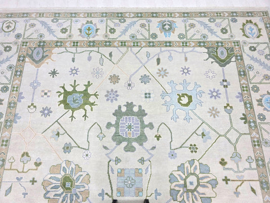 Ivory blue traditional area rug with floral botanical pattern and ornamental border