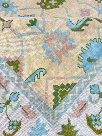 Full view of handmade ivory blue vintage Oushak wool rug with traditional floral pattern.