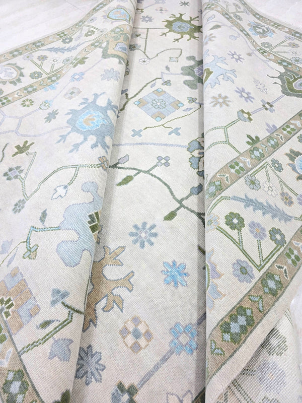 Ivory blue traditional floral area rug with soft blue, sage green and lavender botanical motifs