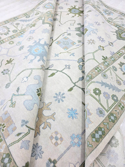 Ivory blue traditional floral area rug with soft blue, sage green and lavender botanical motifs