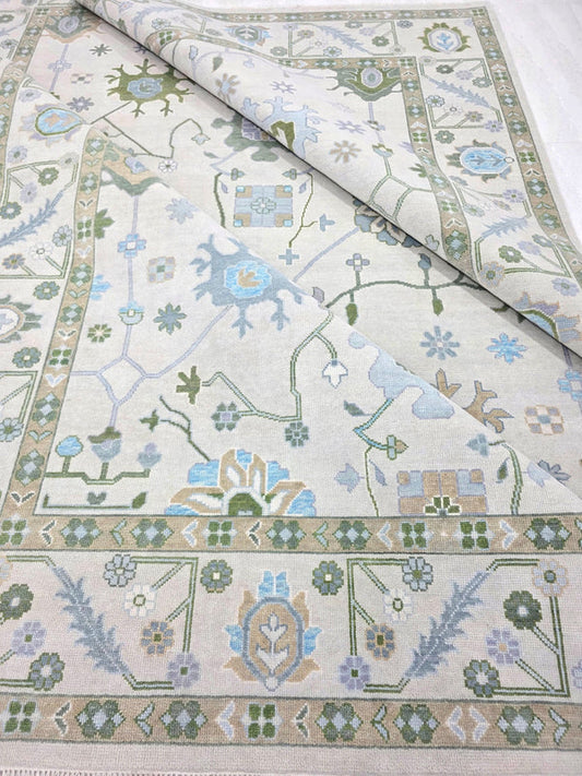 Ivory blue vintage-inspired floral rug showing the central pattern and decorative border
