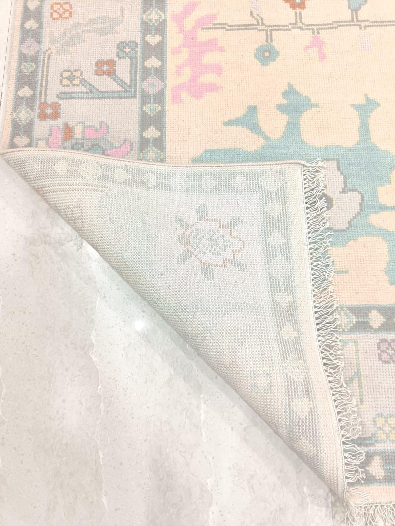 Folded corner showing backside and fringe of handwoven wool rug