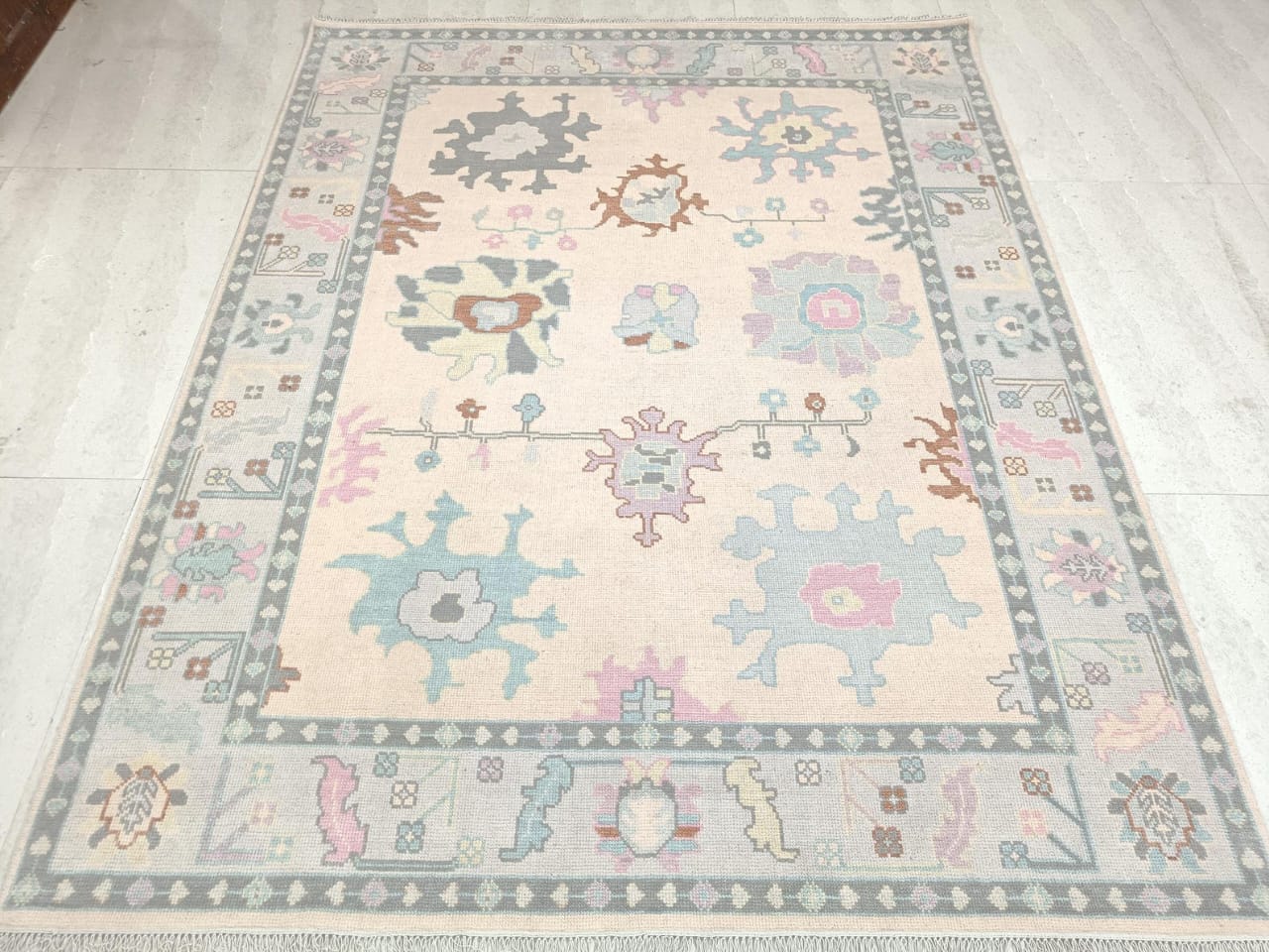 Ivory Oushak handwoven wool rug full view with pastel floral motifs