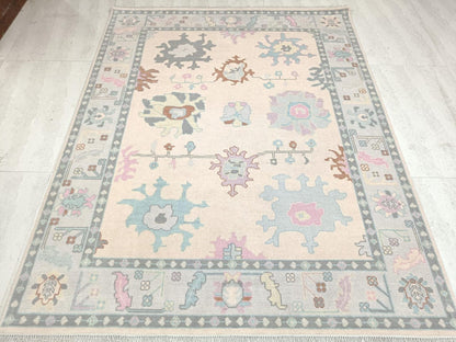 Ivory Oushak handwoven wool rug full view with pastel floral motifs