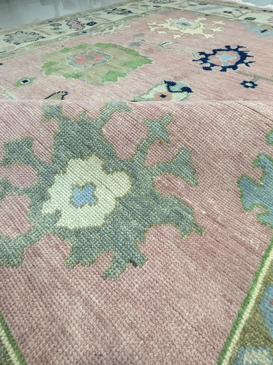 Large handmade blush pink Oushak wool area rug with ivory decorative border