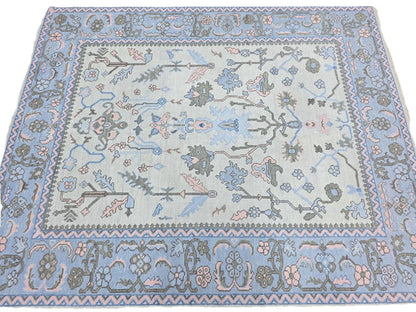 Light blue traditional floral runner rug with pink, sage green and grey botanical design