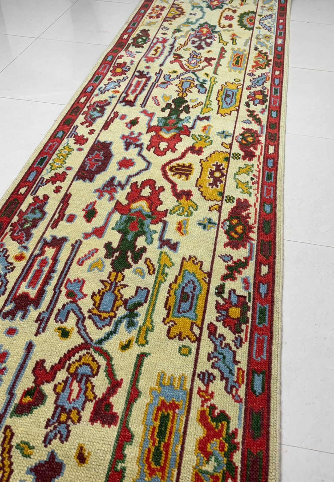 Traditional Oushak rug pattern detail with colorful geometric motifs