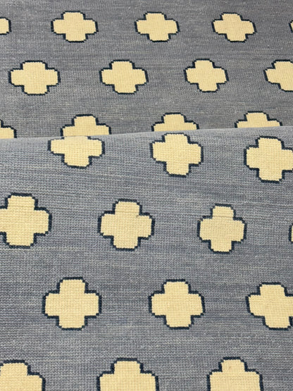Close-up of premium wool texture on a handmade blue geometric rug.