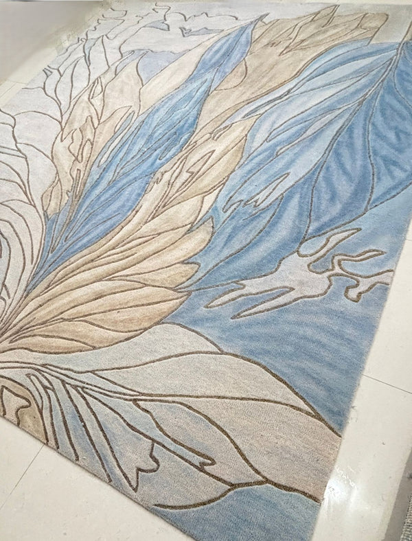 Handmade modern botanical area rug with blue and beige leaf design in contemporary style