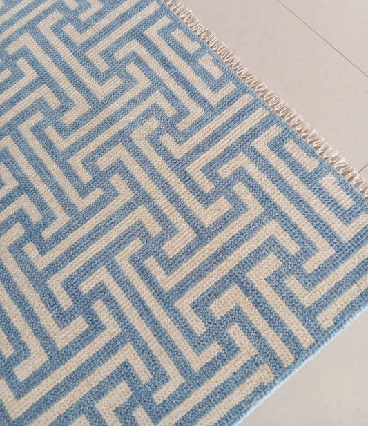 Modern handwoven geometric wool rug in blue and ivory