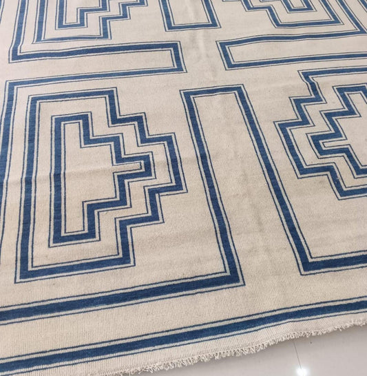 Modern geometric wool area rug in ivory and indigo blue with flatweave construction