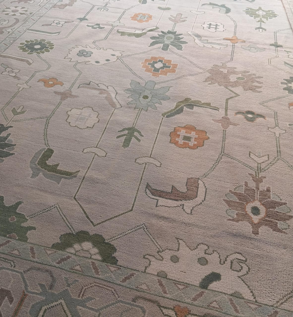 Full view of modern Oushak handwoven wool rug in sage green and blue tones