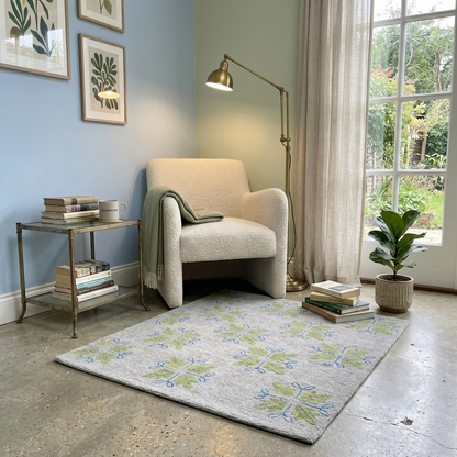 Modern handmade wool accent rug with sage green botanical motifs for reading nook, bedroom or small living room