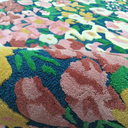 Raised floral pile texture on a multicolor pink and burgundy area rug