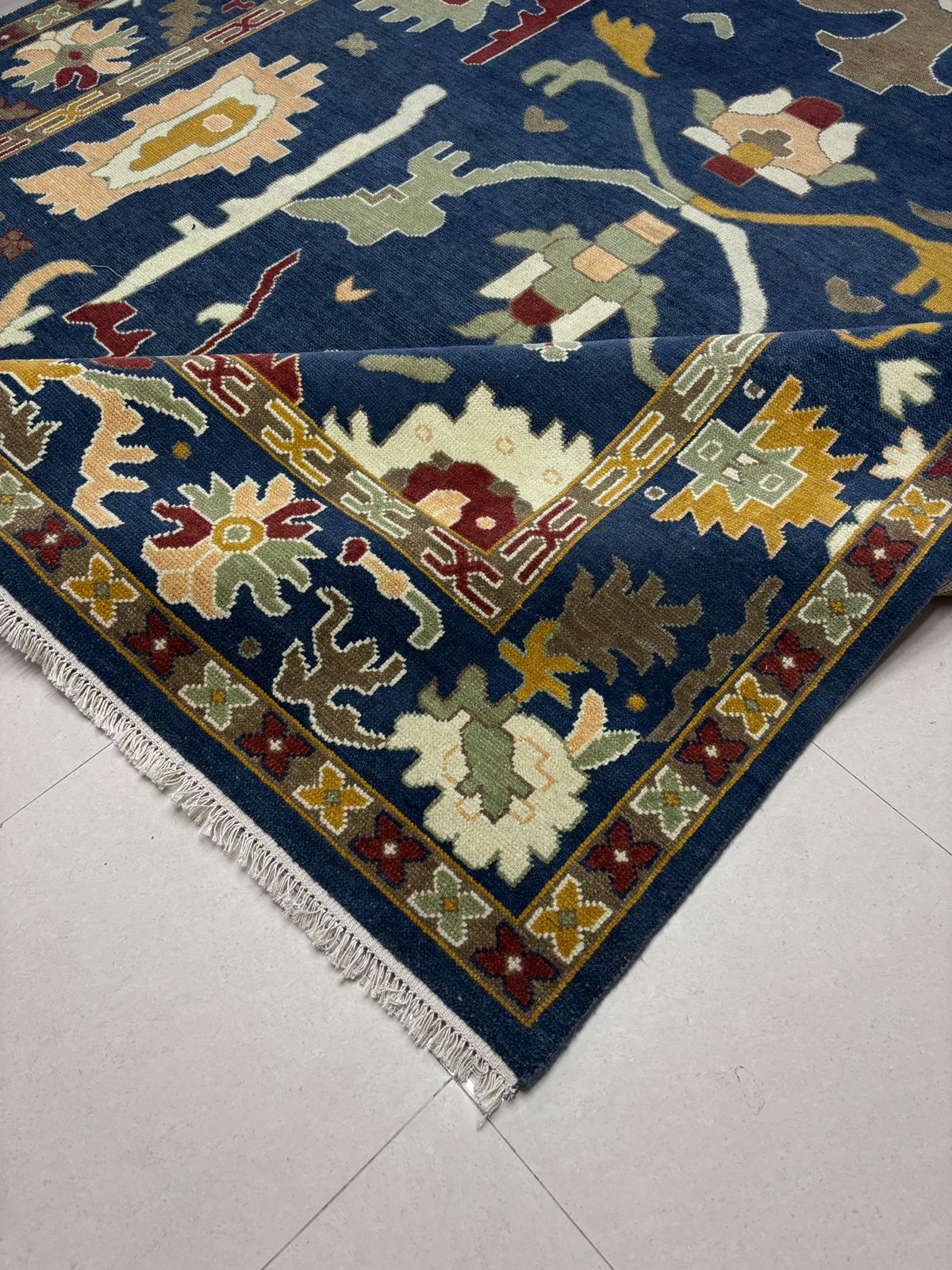 Handmade navy blue Oushak rug with colorful floral motifs and vintage Turkish inspired design
